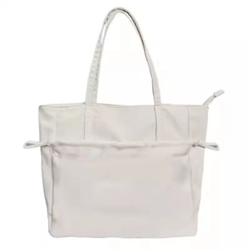 Full front view of the cream tote with drawcord pocket relaxed